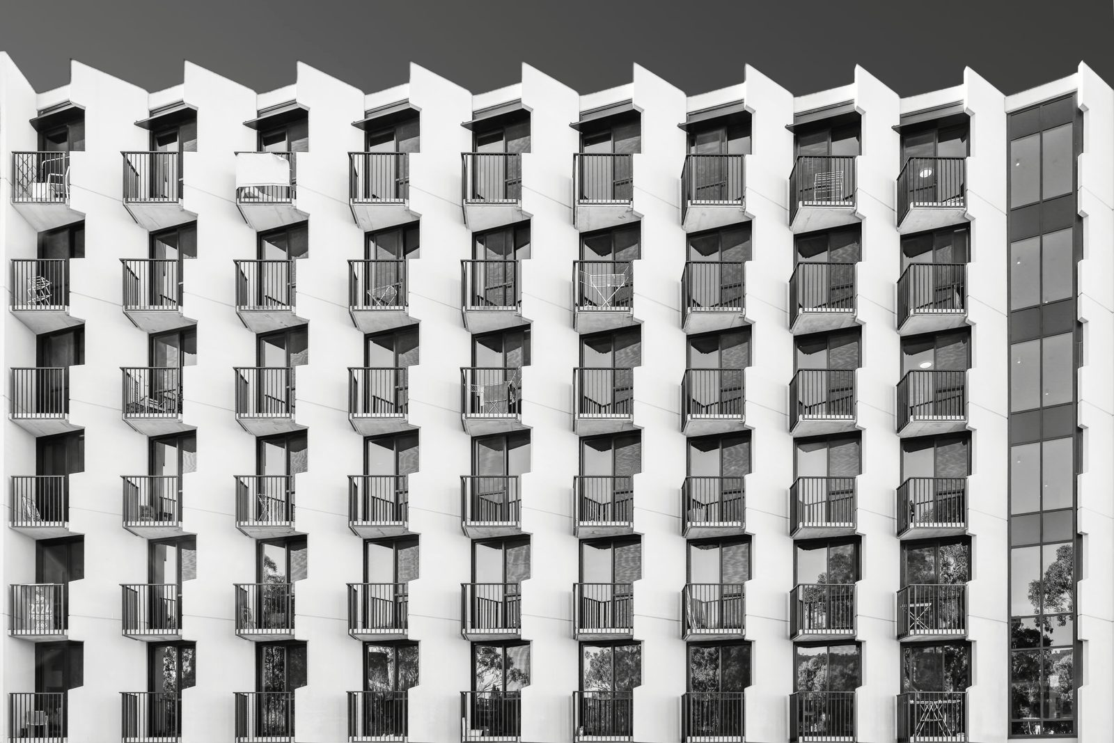 Modern apartment building with long white balconies