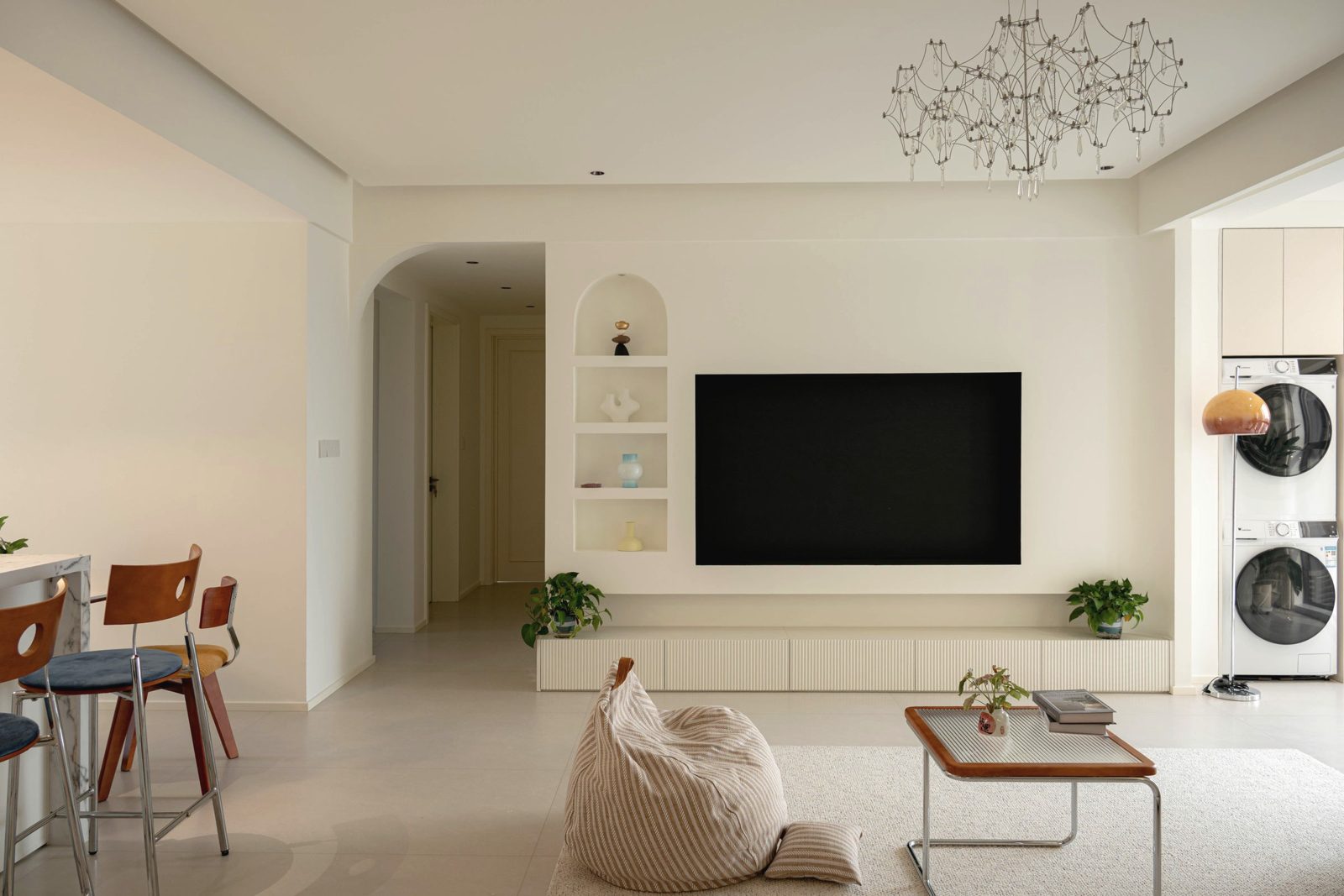 Bright renovated apartment living room with built-in TV wall
